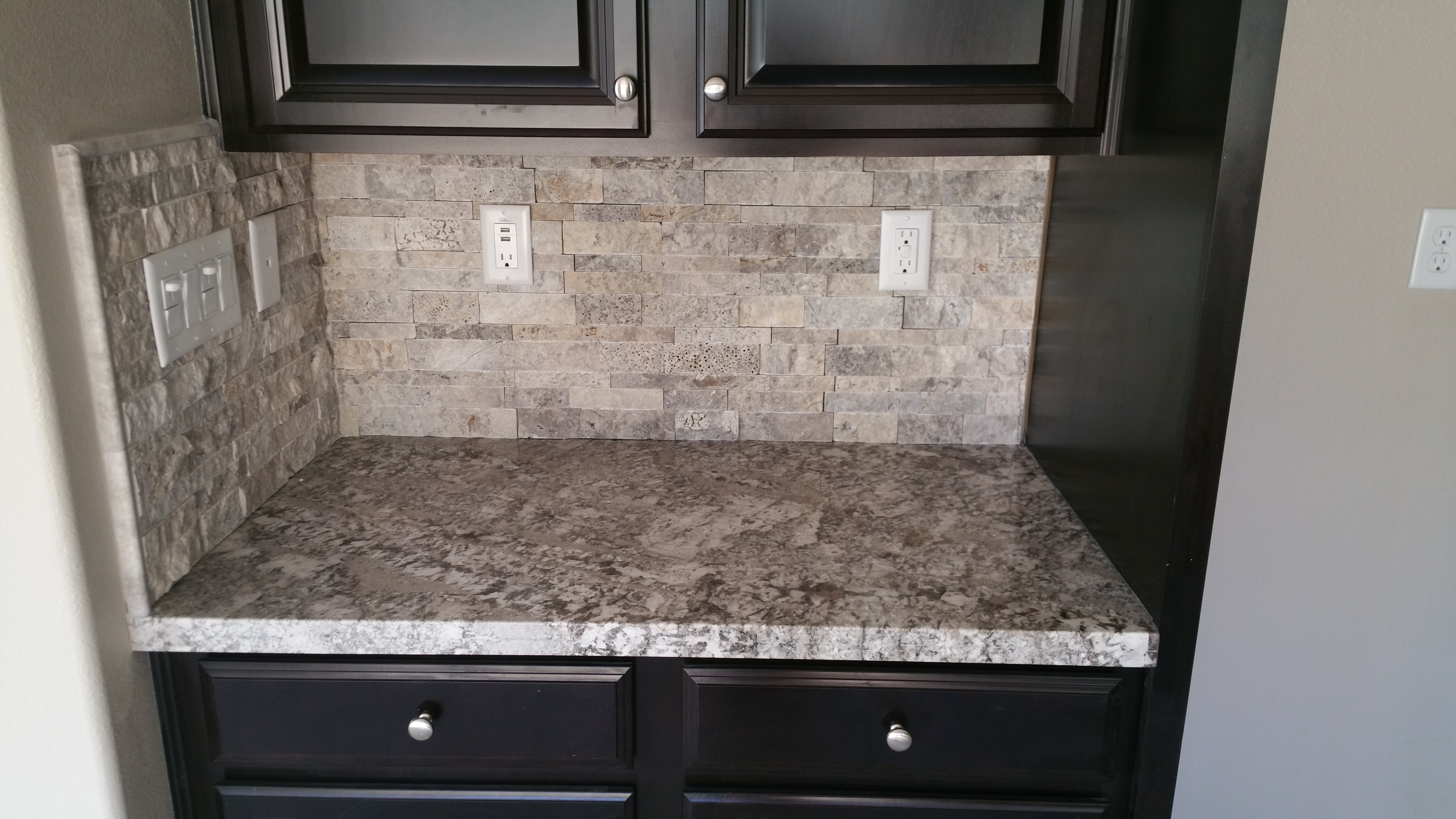 Bianco antico granite with spit face travertine backsplash ...